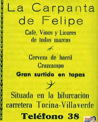 Anuncio antiguo sobre fondo amarillo: La Carpanta de Felipe, café, vinos y licores de todas marcas, cerveza de barril Cruzcampo, gran surtido en tapas, situada en la bifurcación carretera Tocina-Villaverde, teléfono 38.